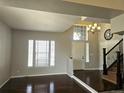 Bright foyer featuring wood flooring, large windows, and grand chandelier at 21580 Longs Peak Ln, Parker, CO 80138