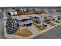 A view of two homes in the suburbs featuring tiled roofs, and ample parking space in the driveways at 4539 Lyndenwood Cir, Highlands Ranch, CO 80130