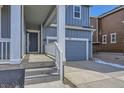 A welcoming front porch and a gray siding detail on this charming home at 735 Sunflower Dr, Brighton, CO 80601