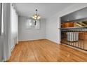 Bright dining area featuring wood floors and contemporary lighting fixtures at 611 Winona Ct, Denver, CO 80204