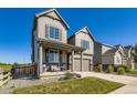 Beautiful two-story home with a well-maintained lawn and attached garage on a sunny day at 607 Azalea St, Brighton, CO 80601