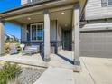 Inviting front porch with stylish seating, stone accents, and a welcoming entrance to the home at 607 Azalea St, Brighton, CO 80601