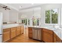 Bright, open kitchen with stainless steel appliances and hardwood floors at 11237 W Ford Dr, Lakewood, CO 80226