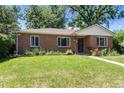 Brick home with manicured front lawn and garden beds, providing great curb appeal at 2635 Julian St, Denver, CO 80211