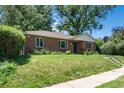 All brick home featuring a well-maintained lawn, lovely landscaping and an inviting front entrance at 2635 Julian St, Denver, CO 80211