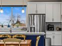 Close-up view of a bright kitchen featuring stainless steel appliances and ample counter space at 6162 W 28Th Ct, Wheat Ridge, CO 80214