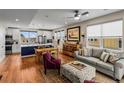 Open-concept living and kitchen area with hardwood floors and stylish decor, with an eat-in table at 6162 W 28Th Ct, Wheat Ridge, CO 80214