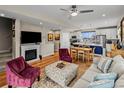 Cozy living room with a fireplace, hardwood floors, and an open layout leading to a modern kitchen at 6162 W 28Th Ct, Wheat Ridge, CO 80214