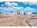 Charming single-story home featuring a barrel tile roof, a circular driveway, and desert landscaping at 7172 S Oakleaf St, Bennett, CO 80102