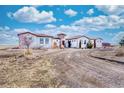 Beautiful single-story home with a barrel tile roof, front courtyard, and a circular driveway at 7172 S Oakleaf St, Bennett, CO 80102