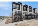Contemporary townhome exterior featuring sleek lines, balconies, and modern architectural details at 2329 Lakeshore Ln # 14, Superior, CO 80027