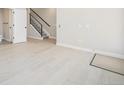 Living room featuring light wood floors, stairs, and a modern interior design at 2329 Lakeshore Ln # 14, Superior, CO 80027
