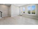Bright living room with white walls, light wood floors, and abundant natural light from large windows at 2329 Lakeshore Ln # 14, Superior, CO 80027