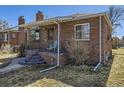 View of a brick home with a covered front porch, showcasing its classic architectural details at 2330 W 46Th Ave, Denver, CO 80211