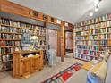 Cozy library with floor-to-ceiling bookshelves and a decorative elephant statue at 24170 Matterhorn Dr, Indian Hills, CO 80454