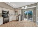 Bright eat-in kitchen with stainless steel appliances and sliding glass doors to the deck at 21789 Farmingdale Way, Parker, CO 80138