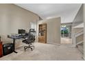 Cozy office area with a view of the staircase and backyard deck at 21789 Farmingdale Way, Parker, CO 80138