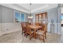 Elegant dining room with a large wooden table, stylish chairs, and a decorative chandelier at 13903 Hillsboro Dr, Parker, CO 80134