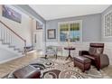 Cozy living room with comfortable seating, a decorative rug, and bright windows at 13903 Hillsboro Dr, Parker, CO 80134