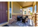 Inviting front porch with comfortable seating and stylish outdoor rug at 24043 E Florida Ave, Aurora, CO 80018