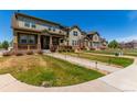 Well-manicured front lawn of attractive home with covered porch in quiet neighborhood at 24043 E Florida Ave, Aurora, CO 80018