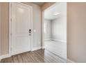 Inviting entryway boasting wood-look floors and neutral walls adjacent to a carpeted living area at 274 Marlowe Dr, Erie, CO 80516