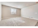 Bright living room featuring neutral carpet, white trim, and natural light through a large window at 274 Marlowe Dr, Erie, CO 80516