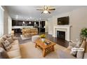 Open concept living room and kitchen with hardwood floors and fireplace at 6327 Agave Ave, Castle Rock, CO 80108