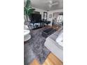 Well-appointed living room with plush rug, stylish furniture, and modern decor at 1977 S Yates S St, Denver, CO 80219