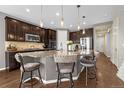Elegant kitchen featuring a granite-topped island, pendant lighting, and sleek stainless steel appliances at 3434 Antelope Ridge Trl, Parker, CO 80138