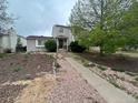 Inviting front yard with walkway leading to the front door at 4320 Nepal St, Denver, CO 80249