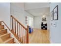 Inviting entryway with hardwood floors and staircase leading to the upper level at 2588 E 116Th Ave, Thornton, CO 80233
