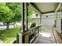 Covered front porch with painted posts and hanging flower baskets at 2588 E 116Th Ave, Thornton, CO 80233
