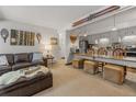 Open-concept living room and kitchen area with comfortable seating, unique decor, and a breakfast bar at 1179 Ski Hill Rd # 147, Breckenridge, CO 80424