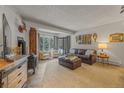 Comfortable living room with wood stove, leather furnishings and natural light streaming through bay window at 1179 Ski Hill Rd # 147, Breckenridge, CO 80424