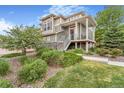 Charming two-story home with landscaped front yard and inviting porch at 18056 E 104Th Way, Commerce City, CO 80022
