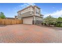 Spacious home with a two-car garage and brick paved driveway at 18056 E 104Th Way, Commerce City, CO 80022