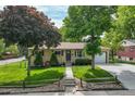 Well-maintained ranch-style home with mature trees and a lush green lawn at 12162 W Dakota Dr, Lakewood, CO 80228