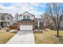 Charming two-story home featuring a brick facade, a two-car garage, and a well-maintained front yard on a sunny day at 3764 Balderas St, Brighton, CO 80601