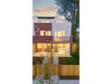 Charming multi-level home showcases a modern design, balconies, and a lovely front yard with mature trees at 1046 N Knox Ct, Denver, CO 80204