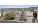 An aerial view showing home's setting in a suburban neighborhood with mountain views at 4526 Lyndenwood Pt, Highlands Ranch, CO 80130