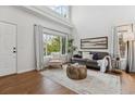 Bright living room featuring hardwood floors, neutral colors, and a cozy seating arrangement at 4526 Lyndenwood Pt, Highlands Ranch, CO 80130