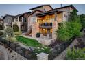 Beautifully landscaped backyard with patio seating and a grill, perfect for outdoor entertaining at 9441 Night Star Pl, Lone Tree, CO 80124