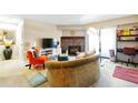 Comfortable living room with fireplace, stylish furnishings, and access to the balcony with natural light at 14208 E 1St Dr # C1, Aurora, CO 80011