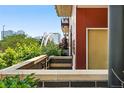 Modern condo entrance showing landscaping and a distant view of the Denver cityscape at 2518 16Th St, Denver, CO 80211