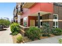 Modern condo with red siding, brick accents, and landscaped entrance, offering urban living at 2518 16Th St, Denver, CO 80211