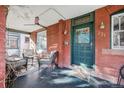 Inviting covered front porch with seating area, ceiling fan, and ornate front door at 231 N Sherman St, Denver, CO 80203