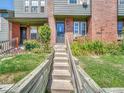 A welcoming exterior view highlights the front steps and wooden retaining wall at 17427 E Rice Cir # C, Aurora, CO 80015