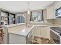 Bright kitchen with stainless steel appliances, white cabinetry, and quartz countertops provides a modern cooking space at 17427 E Rice Cir # C, Aurora, CO 80015