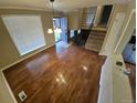 Bright living room featuring hardwood floors and an open staircase, creating an inviting space at 1962 S Ivory Way, Aurora, CO 80013